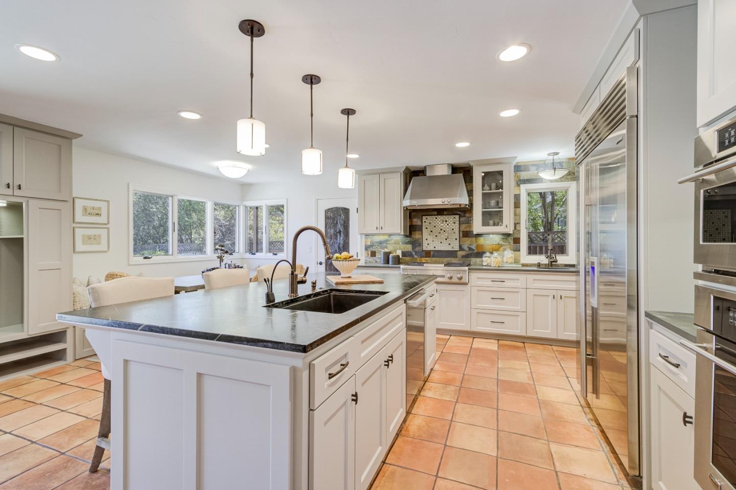 370 Quinnhill Road Los Altos, CA 94024 - Photo 19 of 58 a kitchen with stainless steel appliances granite countertop a sink a stove and a wooden cabinets