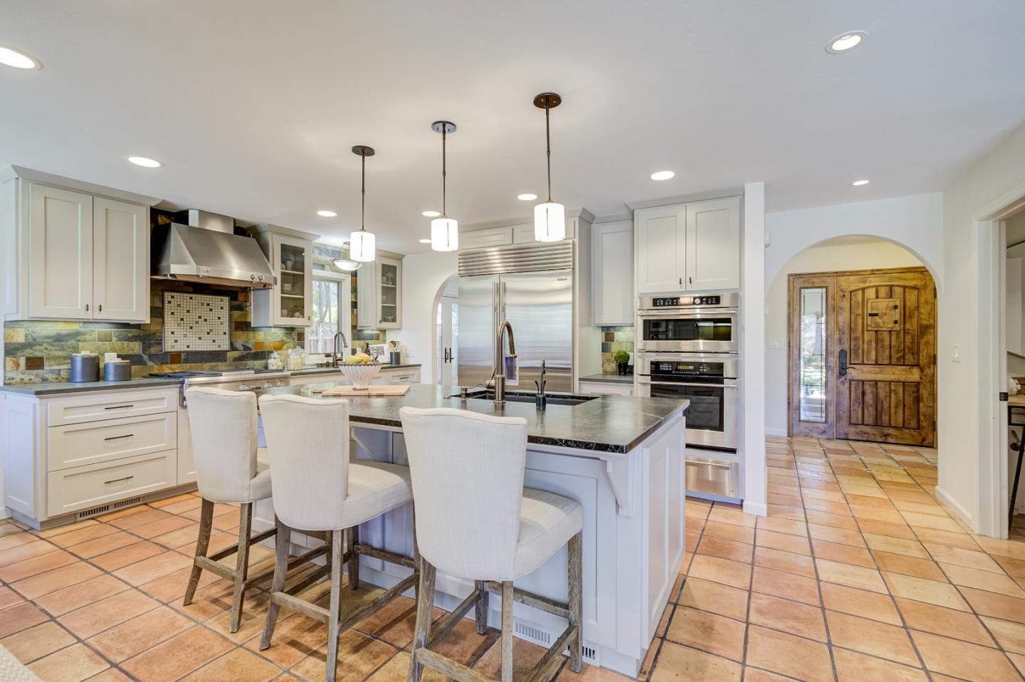 370 Quinnhill Road Los Altos, CA 94024 - Photo 21 of 58 a kitchen with kitchen island granite countertop lots of white cabinets appliances and furniture