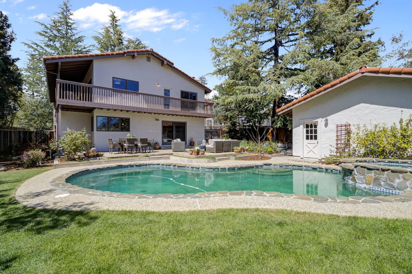 370 Quinnhill Road Los Altos, CA 94024 - Photo 49 of 58 a view of a house with swimming pool and a table and chairs under an umbrella
