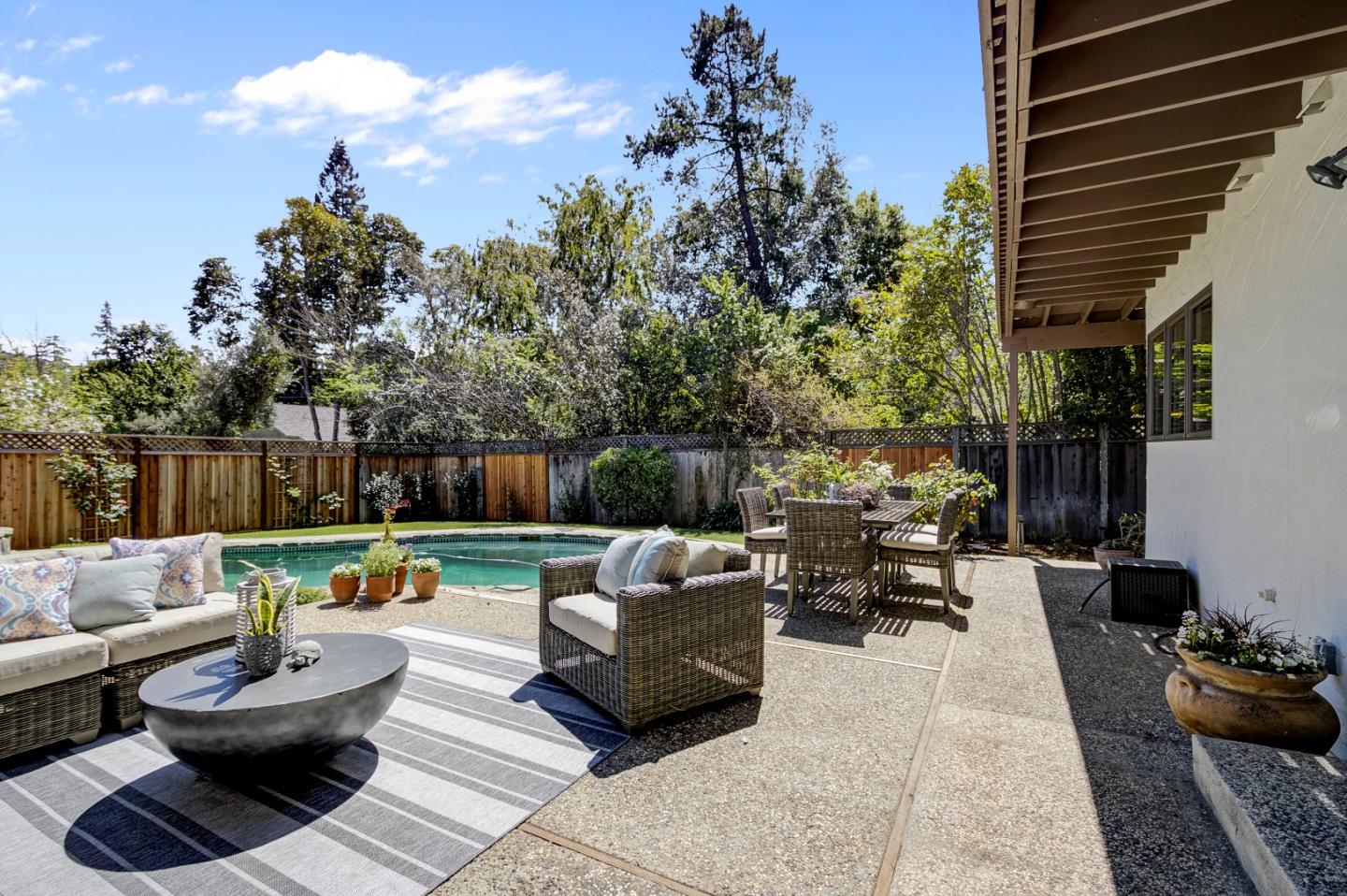 370 Quinnhill Road Los Altos, CA 94024 - Photo 53 of 58 a view of a patio with couches and a potted plant on a table and chairs
