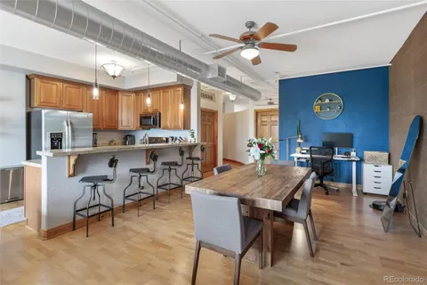 a kitchen with stainless steel appliances granite countertop a refrigerator a stove top oven a sink and dishwasher