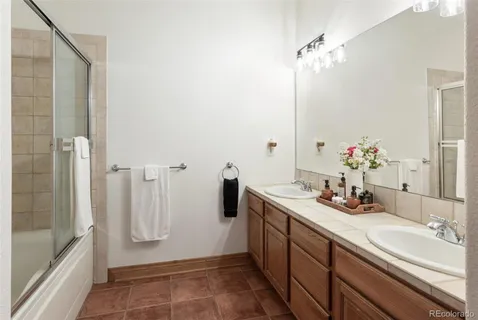 a bathroom with a sink double vanity and a mirror
