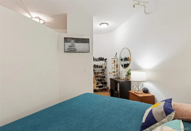 a bedroom with a bed and a dresser