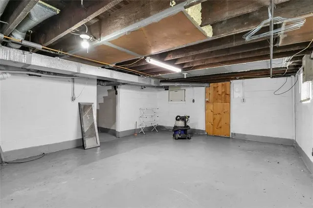 a view of a kitchen with refrigerator and chairs