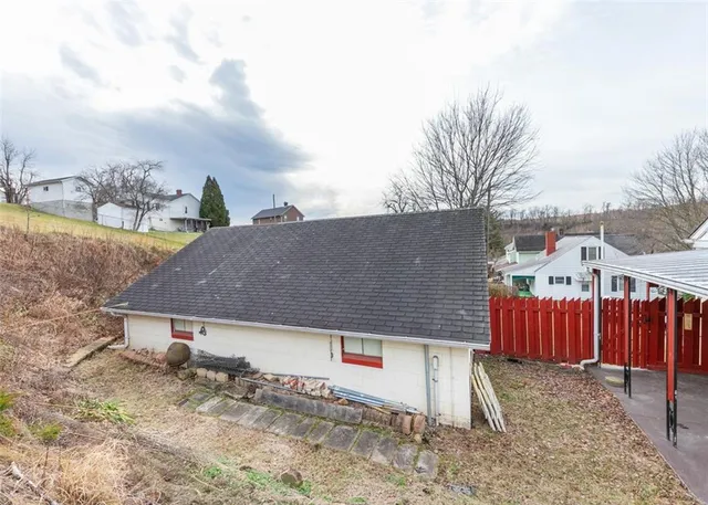 a view of a house with a yard and sitting area