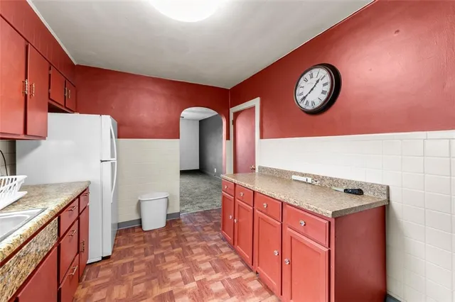 a kitchen with a stove a sink and a refrigerator