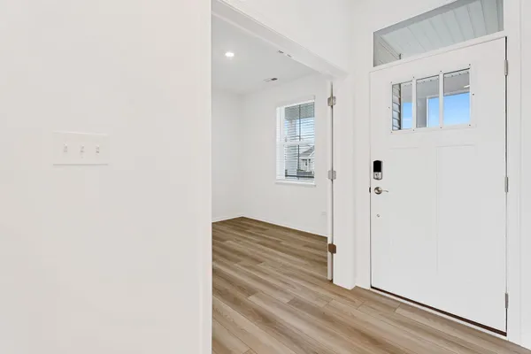 a view of wooden floor and closet in a room