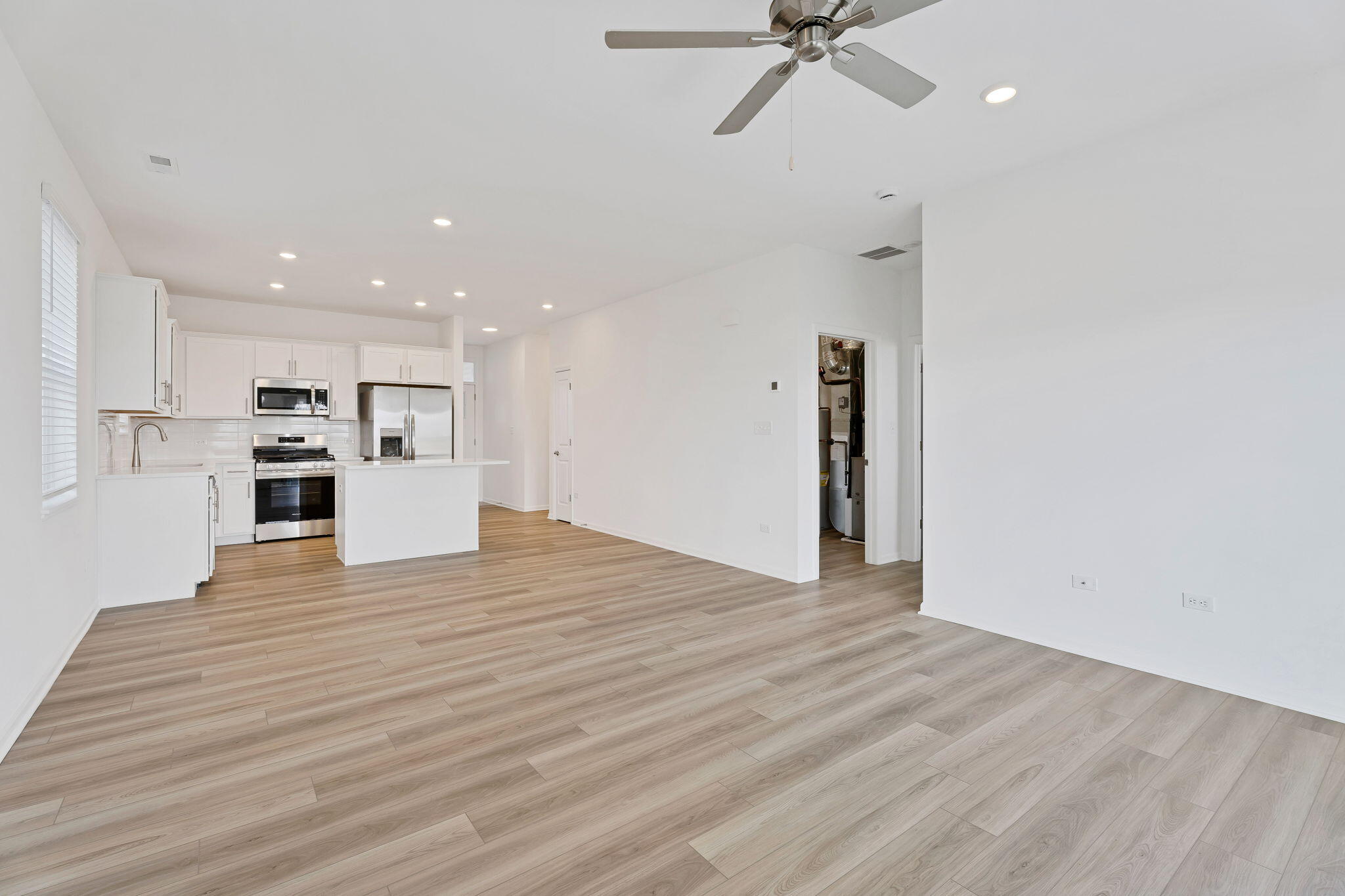 511 East 127th Place Crown Point, IN 46307 - Photo 9 of 22 a view of a kitchen with a sink and a refrigerator