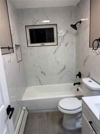 a bathroom with a sink a toilet and bathtub