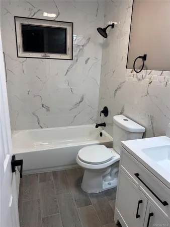 a bathroom with a toilet a sink and a mirror
