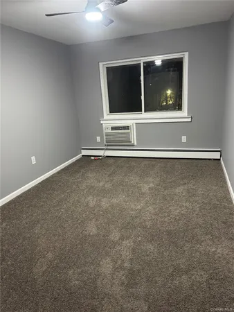 an empty room with window and pillar in it