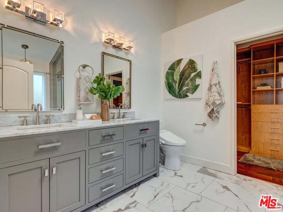2031 Walnut Avenue Venice, CA 90291 - Photo 21 of 29 a bathroom with a granite countertop toilet sink and mirror