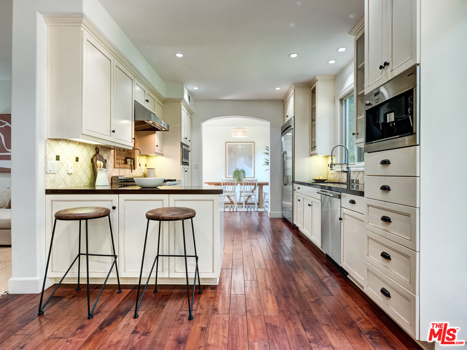 2031 Walnut Avenue Venice, CA 90291 - Photo 9 of 29 a large kitchen with stainless steel appliances kitchen island granite countertop a stove a sink and a microwave