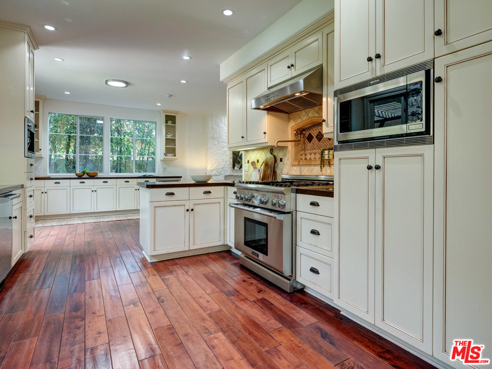 2031 Walnut Avenue Venice, CA 90291 - Photo 10 of 29 a kitchen with stainless steel appliances a white stove top oven and a sink