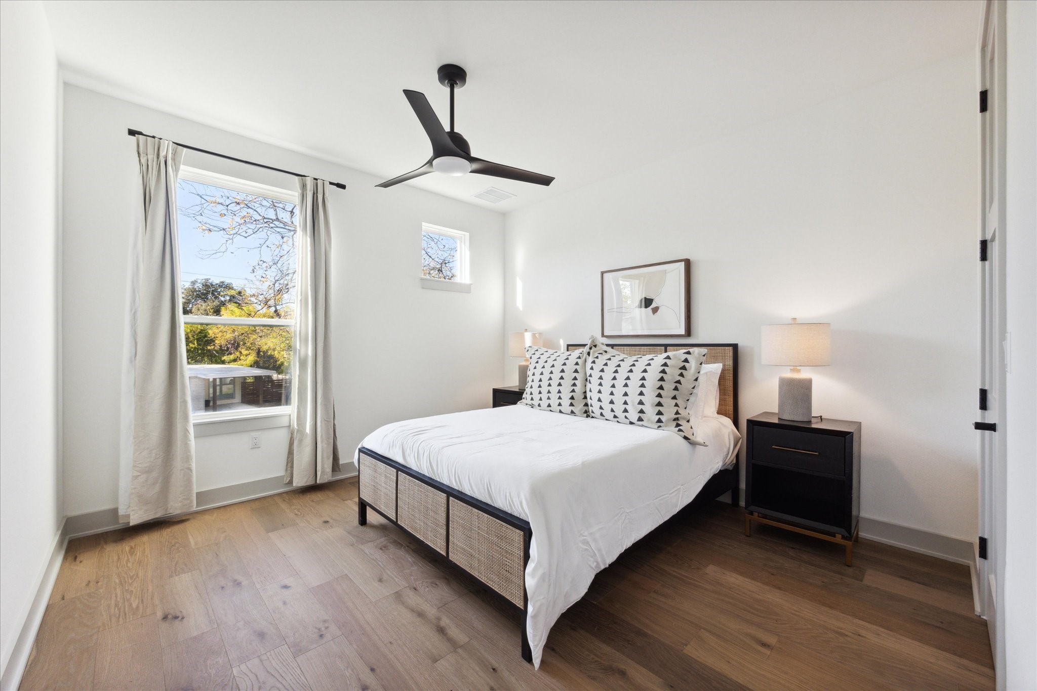 3001 Funston Street Austin, TX 78703 - Photo 15 of 27 a bedroom with a bed lamp and a window