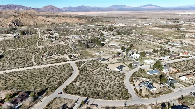 an aerial view of residential house and sandy dunes