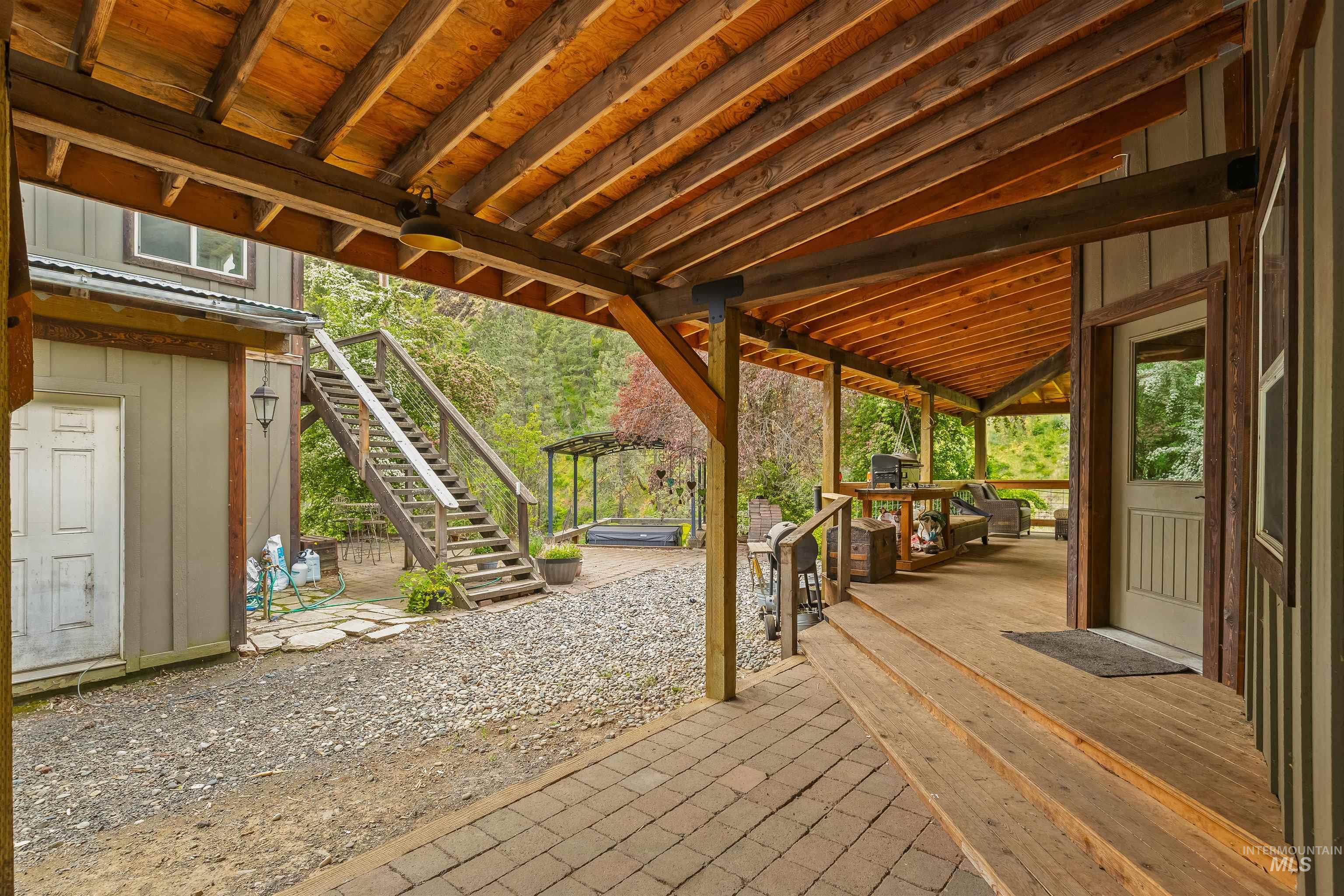 1314 Cedar Ridge Road Kendrick, ID 83537 - Photo 7 of 50 Expansive covered wood-finish porch with exposed beam ceiling, wood-finish flooring, and paver stone entry
