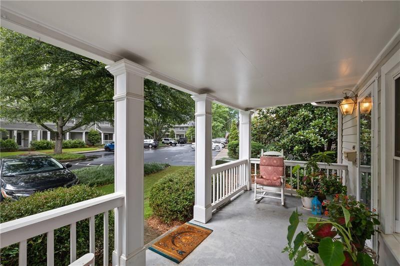 a view of a porch with chairs and backyard
