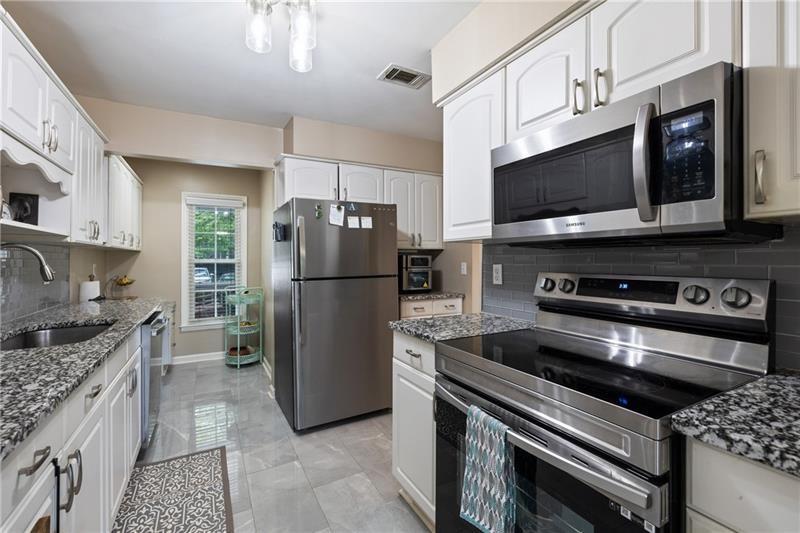 2674 Farmstead Road Smyrna, GA 30080 - Photo 13 of 25 a kitchen with a refrigerator stove and microwave