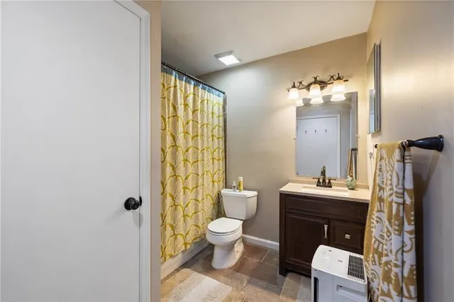 a bathroom with a toilet a sink and a mirror