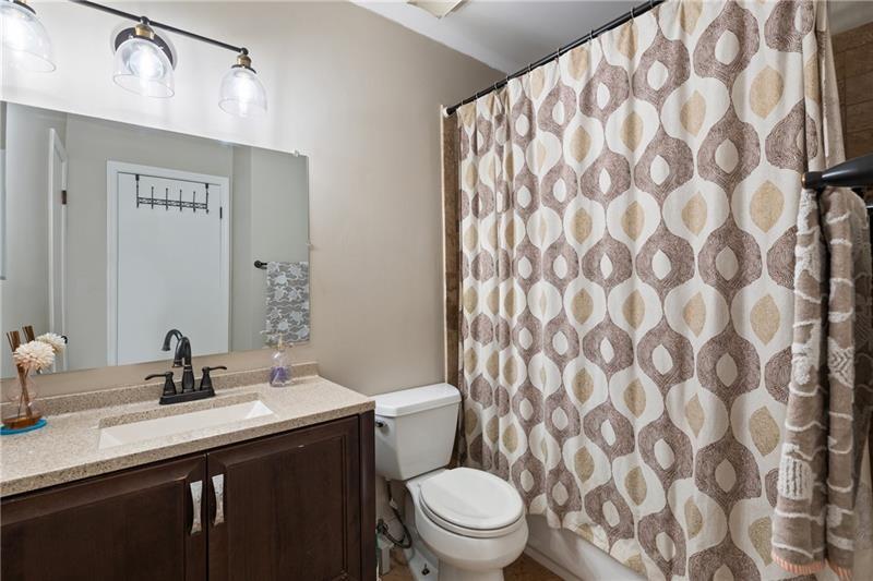 2674 Farmstead Road Smyrna, GA 30080 - Photo 22 of 25 a bathroom with a granite countertop sink and a toilet