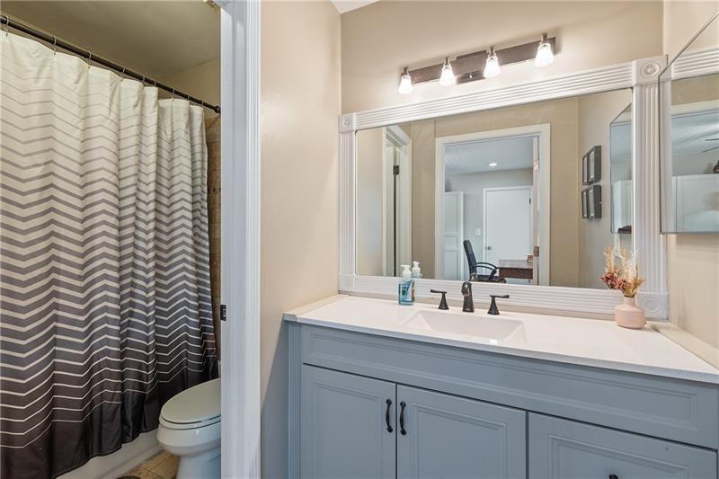 2674 Farmstead Road Smyrna, GA 30080 - Photo 25 of 25 a bathroom with a sink a toilet and a mirror