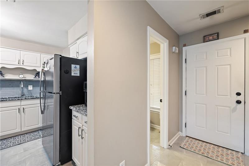 2674 Farmstead Road Smyrna, GA 30080 - Photo 4 of 25 a view of a kitchen with refrigerator and wooden cabinets