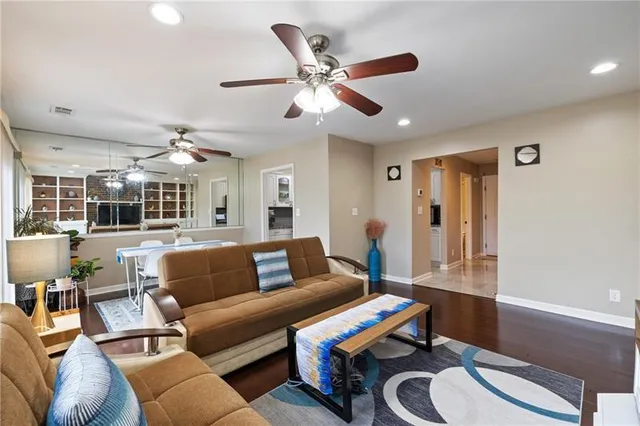 a living room with furniture and wooden floor