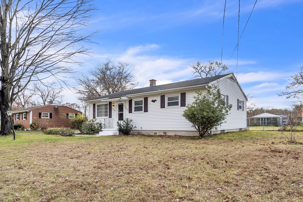 82 Louis Road Springfield, MA 01118 - Photo 2 of 24 a front view of a house with a garden