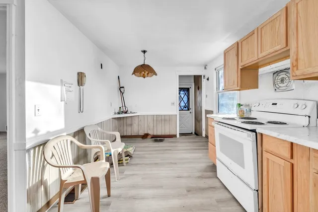 a kitchen with stainless steel appliances granite countertop a stove and white cabinets