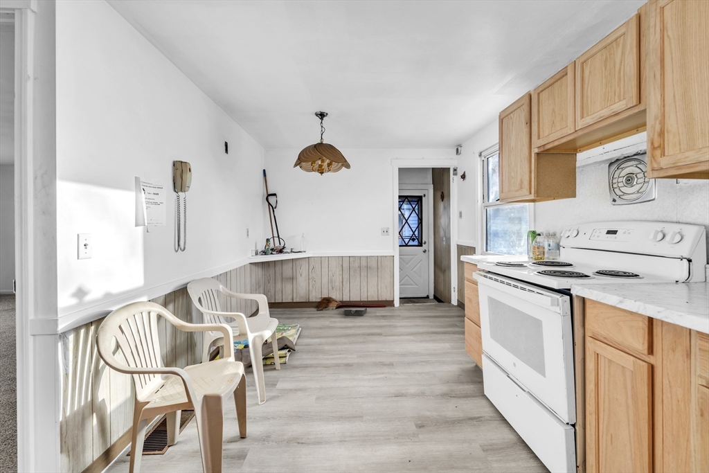 82 Louis Road Springfield, MA 01118 - Photo 7 of 24 a kitchen with stainless steel appliances granite countertop a stove and white cabinets