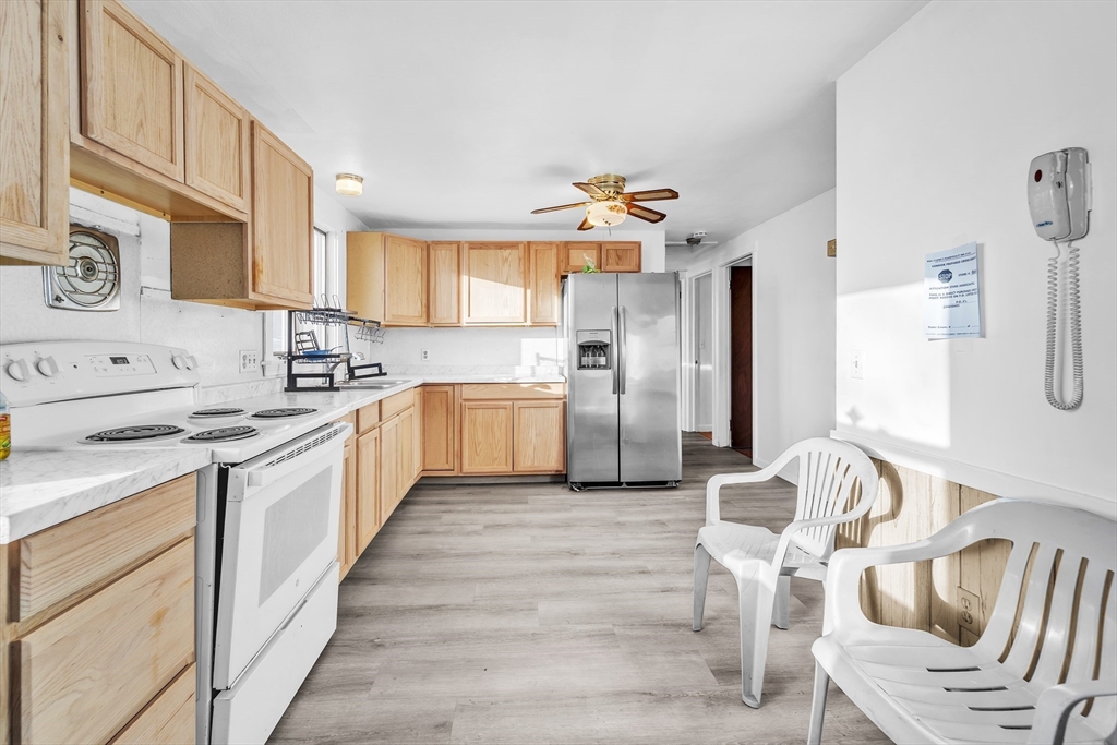 82 Louis Road Springfield, MA 01118 - Photo 8 of 24 a large kitchen with stainless steel appliances kitchen island granite countertop a refrigerator and a stove top oven