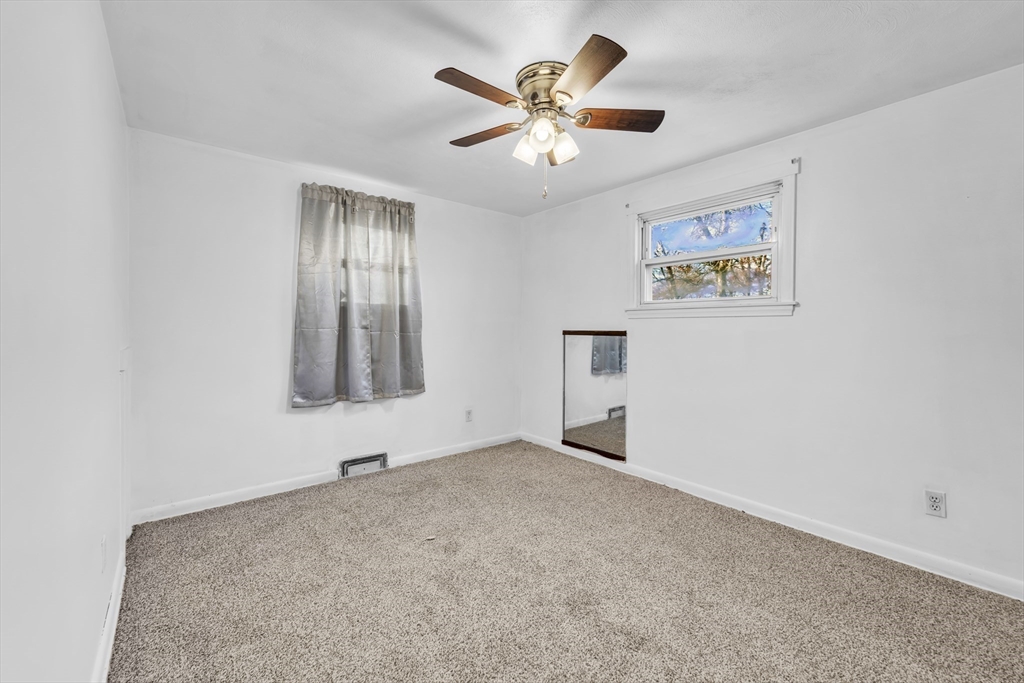 82 Louis Road Springfield, MA 01118 - Photo 9 of 24 an empty room with windows and fan