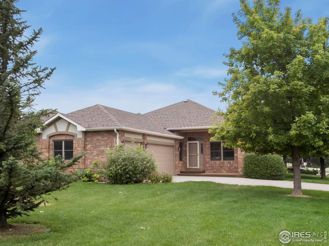 8209 Spinnaker Bay Drive Windsor, CO 80528 - Photo 1 of 26 a front view of a house with a garden