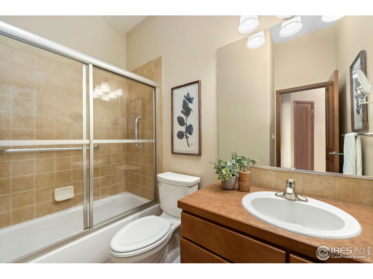 8209 Spinnaker Bay Drive Windsor, CO 80528 - Photo 14 of 26 a bathroom with a toilet a sink and mirror