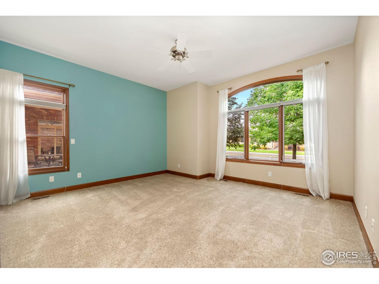 8209 Spinnaker Bay Drive Windsor, CO 80528 - Photo 15 of 26 a view of an empty room with a window