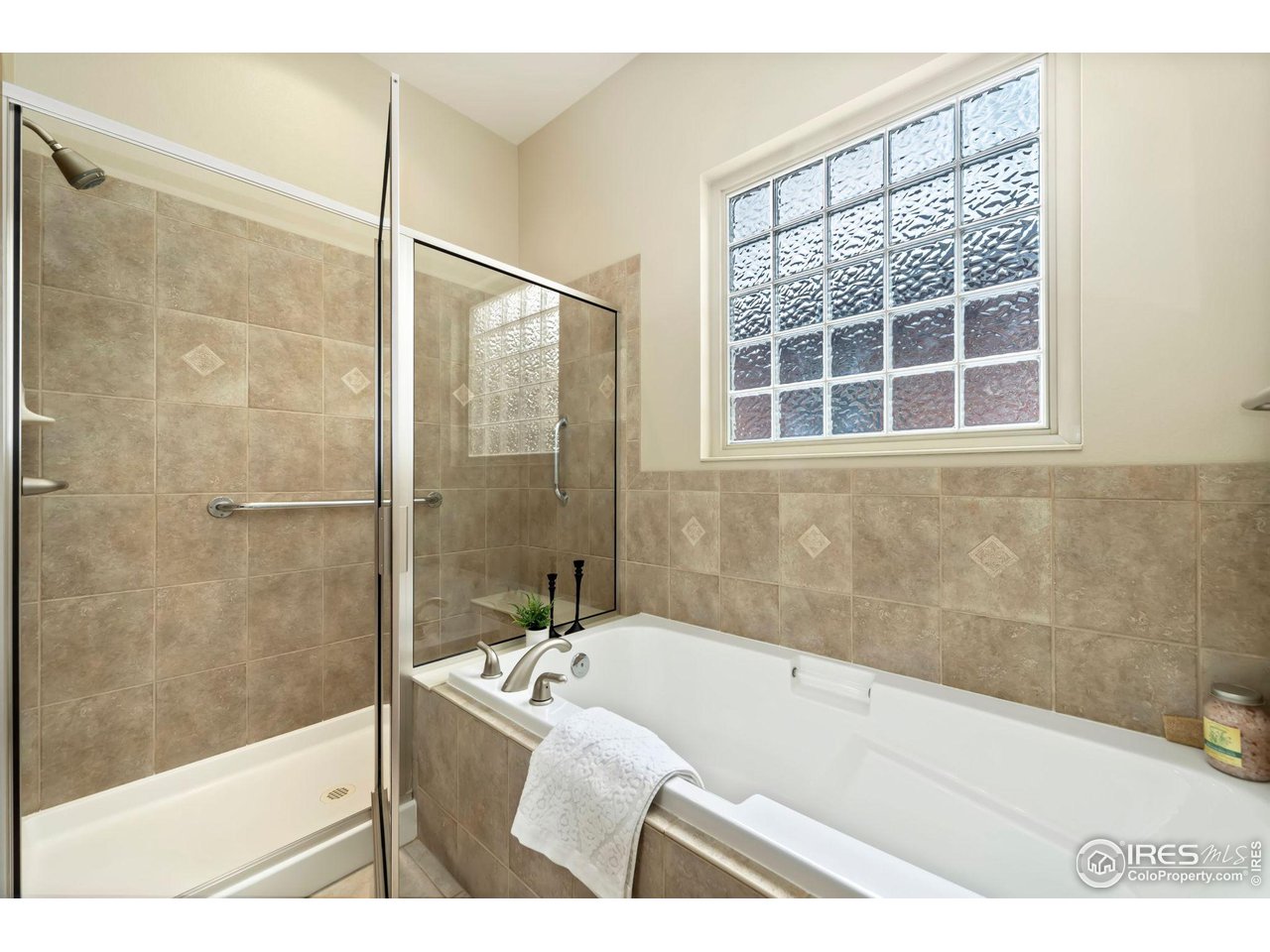 8209 Spinnaker Bay Drive Windsor, CO 80528 - Photo 18 of 26 a bathroom with a granite countertop tub shower and sink