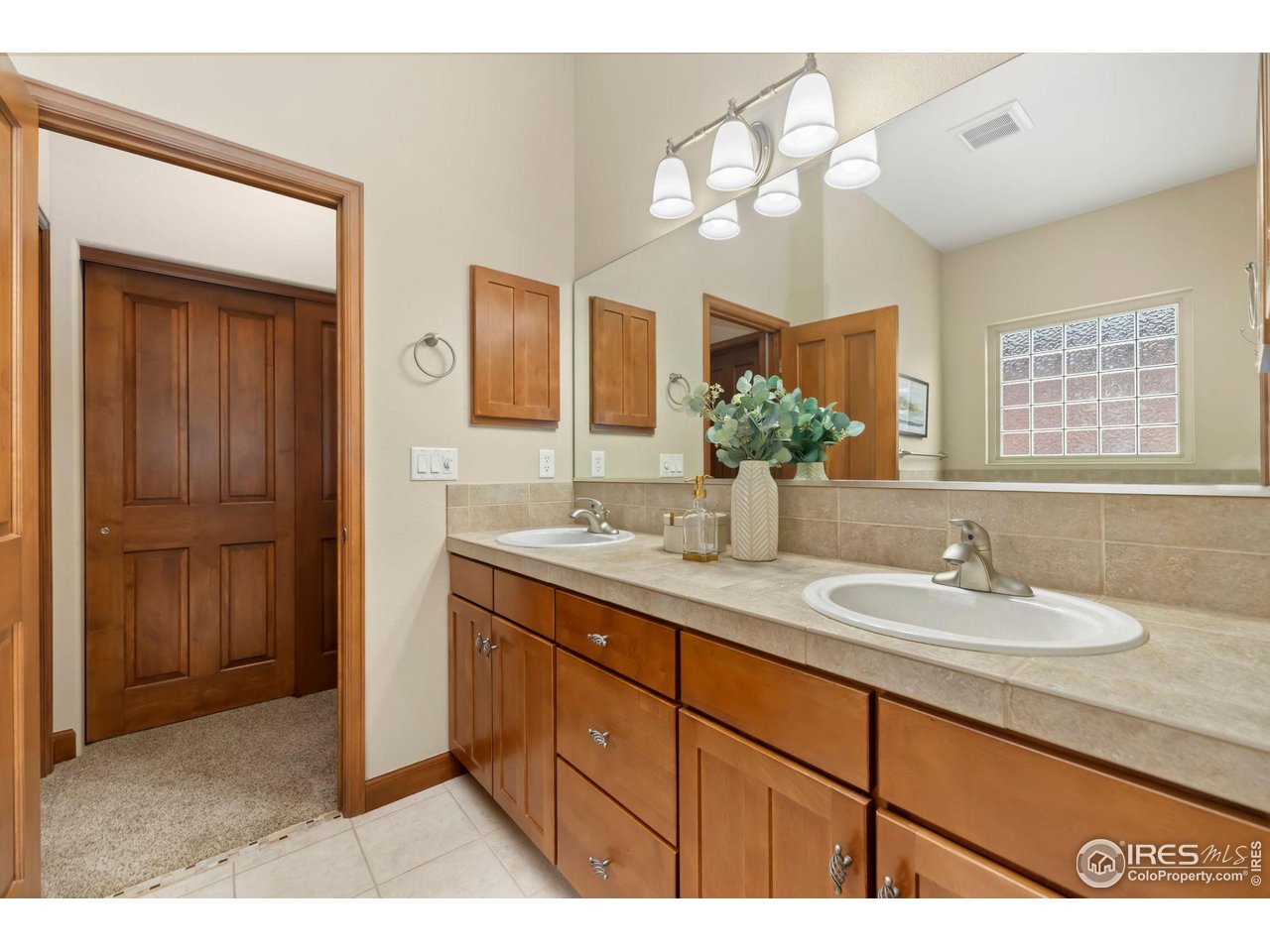 8209 Spinnaker Bay Drive Windsor, CO 80528 - Photo 19 of 26 a bathroom with a sink double vanity and a mirror