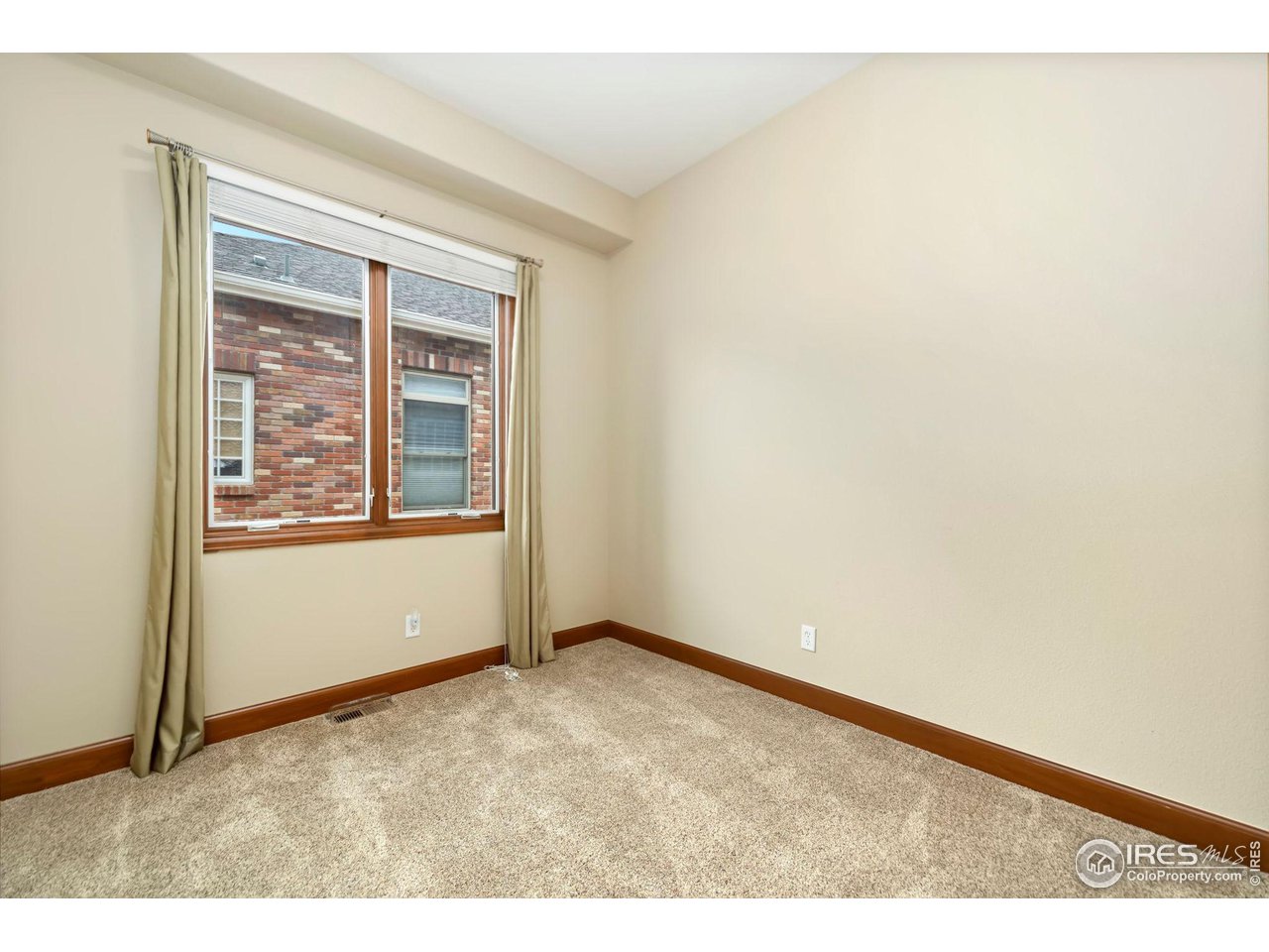 8209 Spinnaker Bay Drive Windsor, CO 80528 - Photo 22 of 26 a view of an empty room with a window