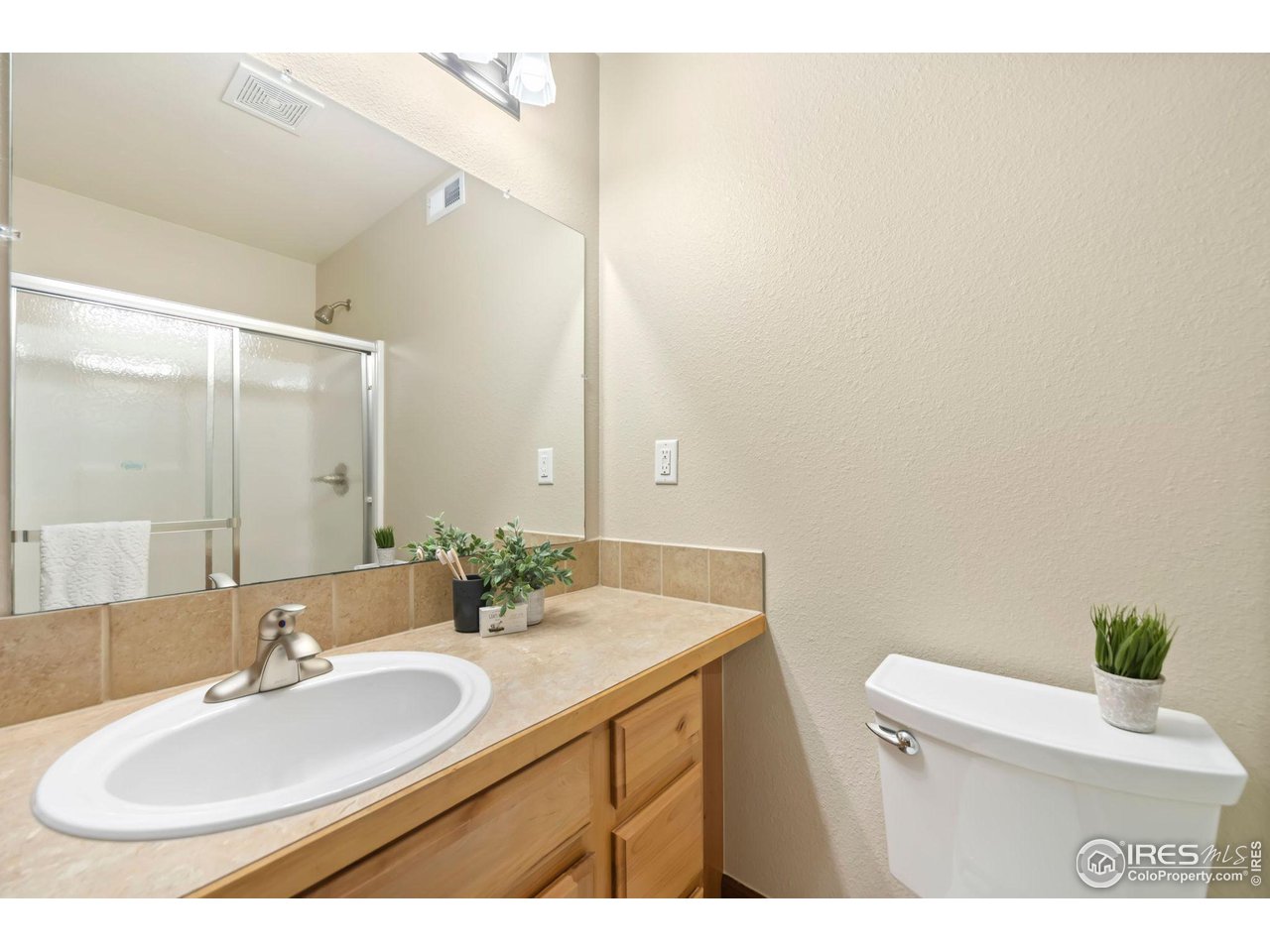 8209 Spinnaker Bay Drive Windsor, CO 80528 - Photo 24 of 26 a bathroom with a sink and a mirror