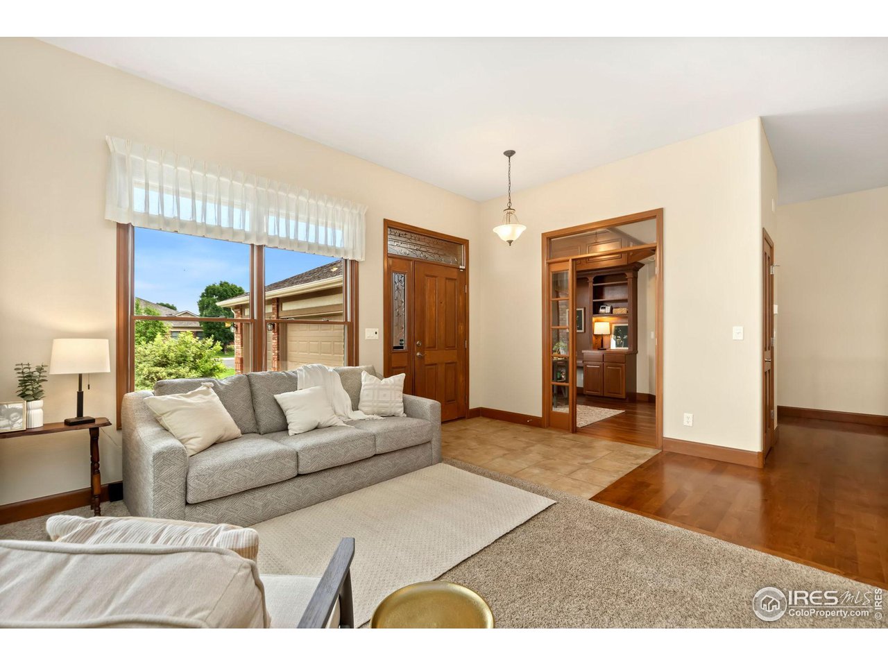 8209 Spinnaker Bay Drive Windsor, CO 80528 - Photo 5 of 26 a living room with furniture and a wooden floor