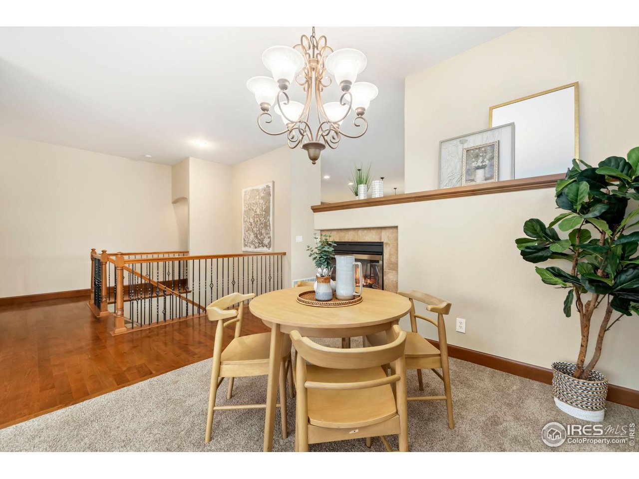 8209 Spinnaker Bay Drive Windsor, CO 80528 - Photo 7 of 26 a dining room with wooden floor a chandelier a wooden table and chairs