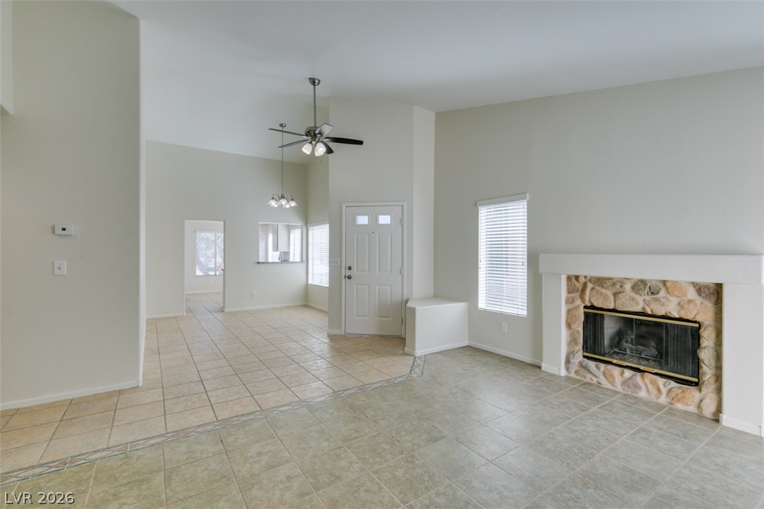307 Cavalla Street Henderson, NV 89074 - Photo 11 of 44 A spacious living area offers a rustic stone fireplace and ample natural light.