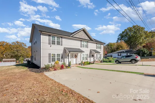 a front view of a house with a yard and a garage