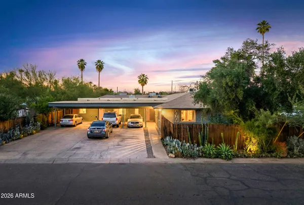 a view of swimming pool with seating space and trees in the background