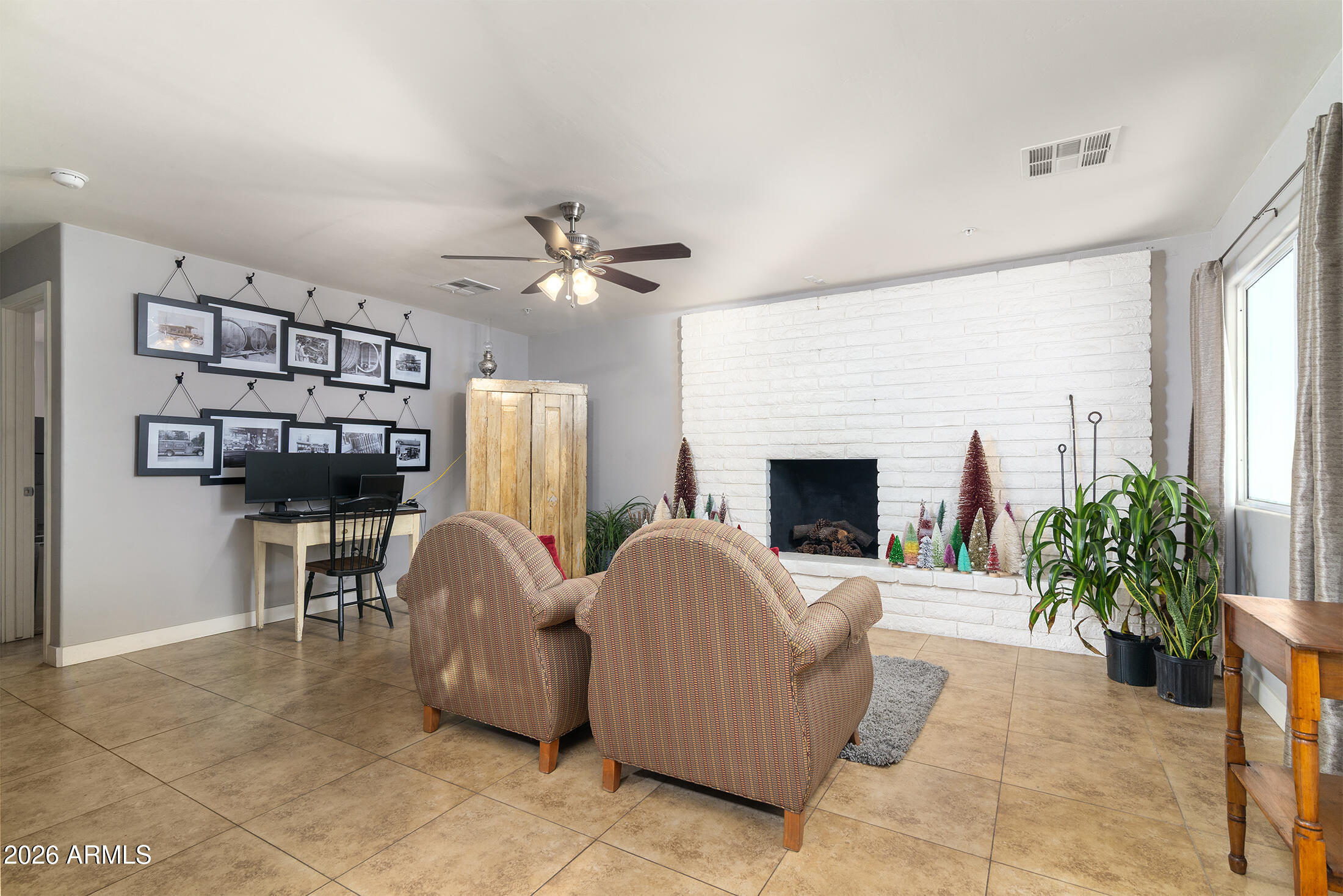 822 East Montecito Avenue Phoenix, AZ 85014 - Photo 11 of 48 a living room with furniture a fireplace and a potted plant