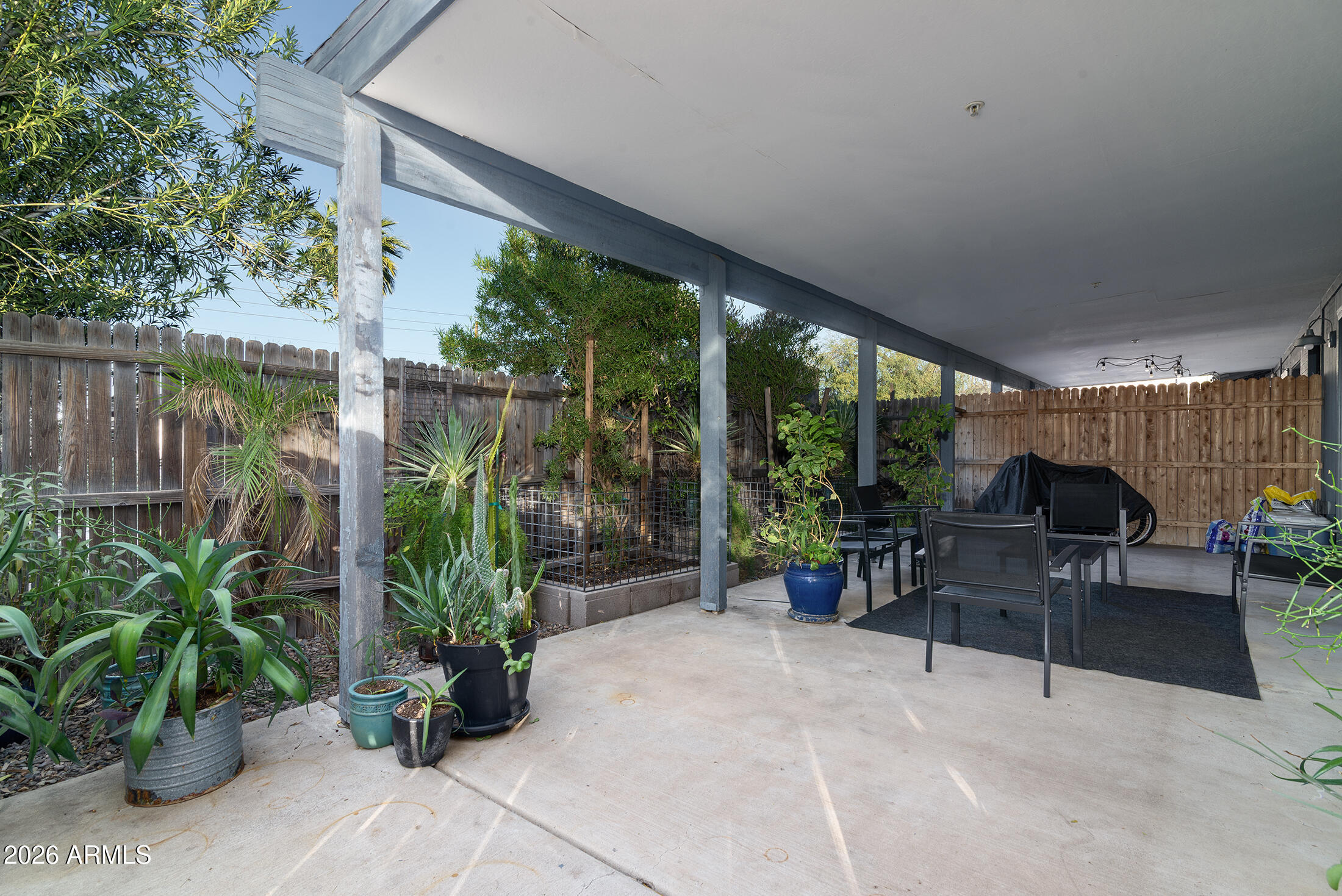 822 East Montecito Avenue Phoenix, AZ 85014 - Photo 19 of 48 a view of a patio with couches table and chairs potted plants and large tree