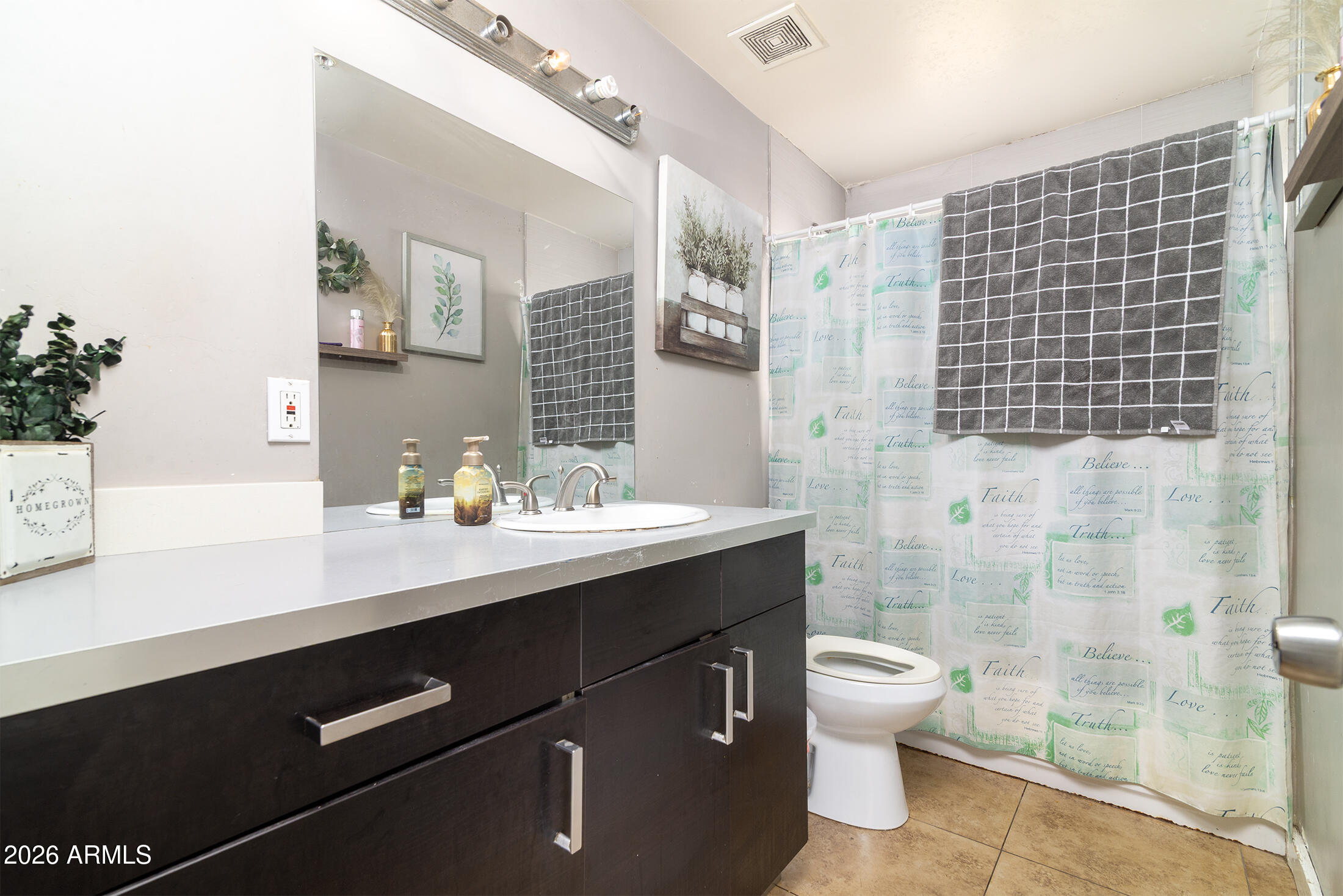 822 East Montecito Avenue Phoenix, AZ 85014 - Photo 32 of 48 a bathroom with a sink a toilet a shower and a mirror