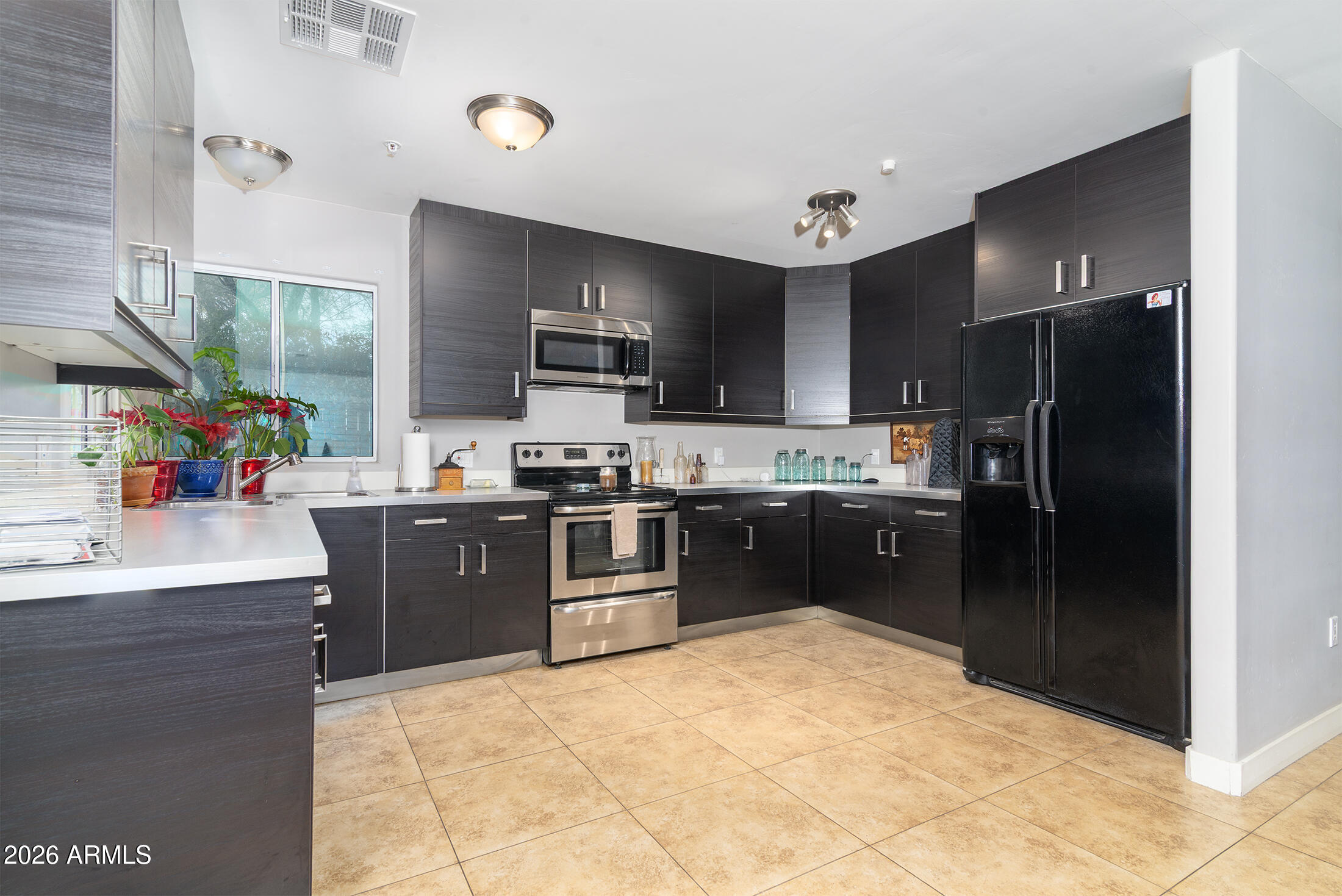 822 East Montecito Avenue Phoenix, AZ 85014 - Photo 9 of 48 a kitchen with granite countertop a refrigerator and a sink