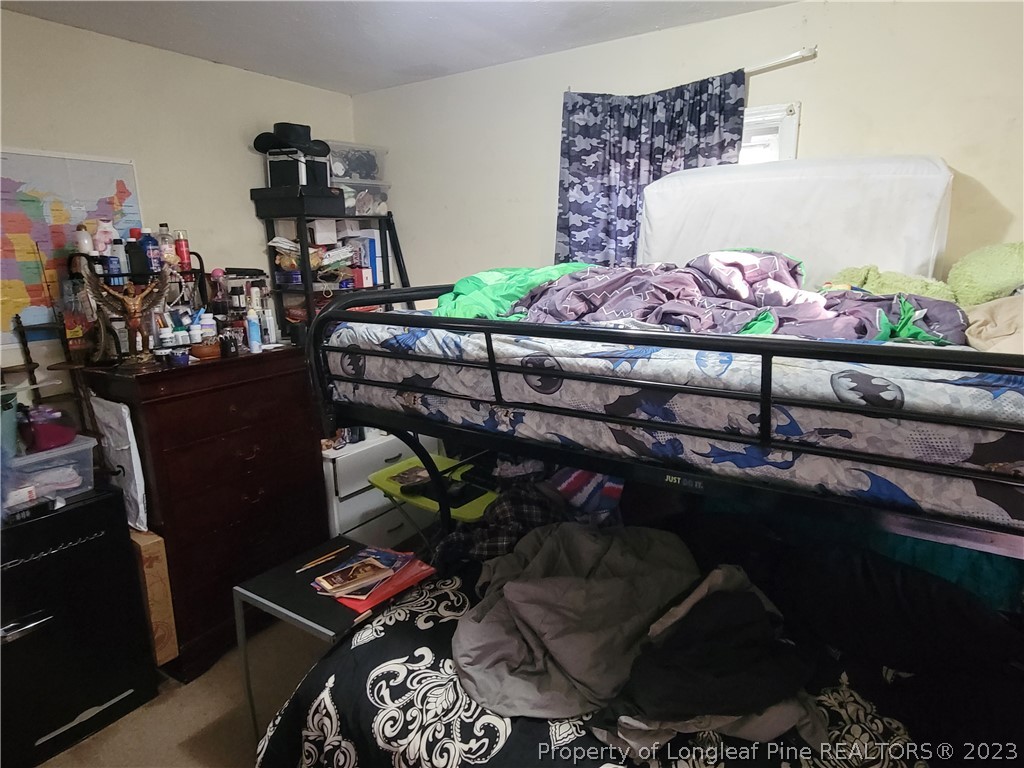 705 Eva Circle Spring Lake, NC 28390 - Photo 12 of 21 a room with lots of furniture and clutter